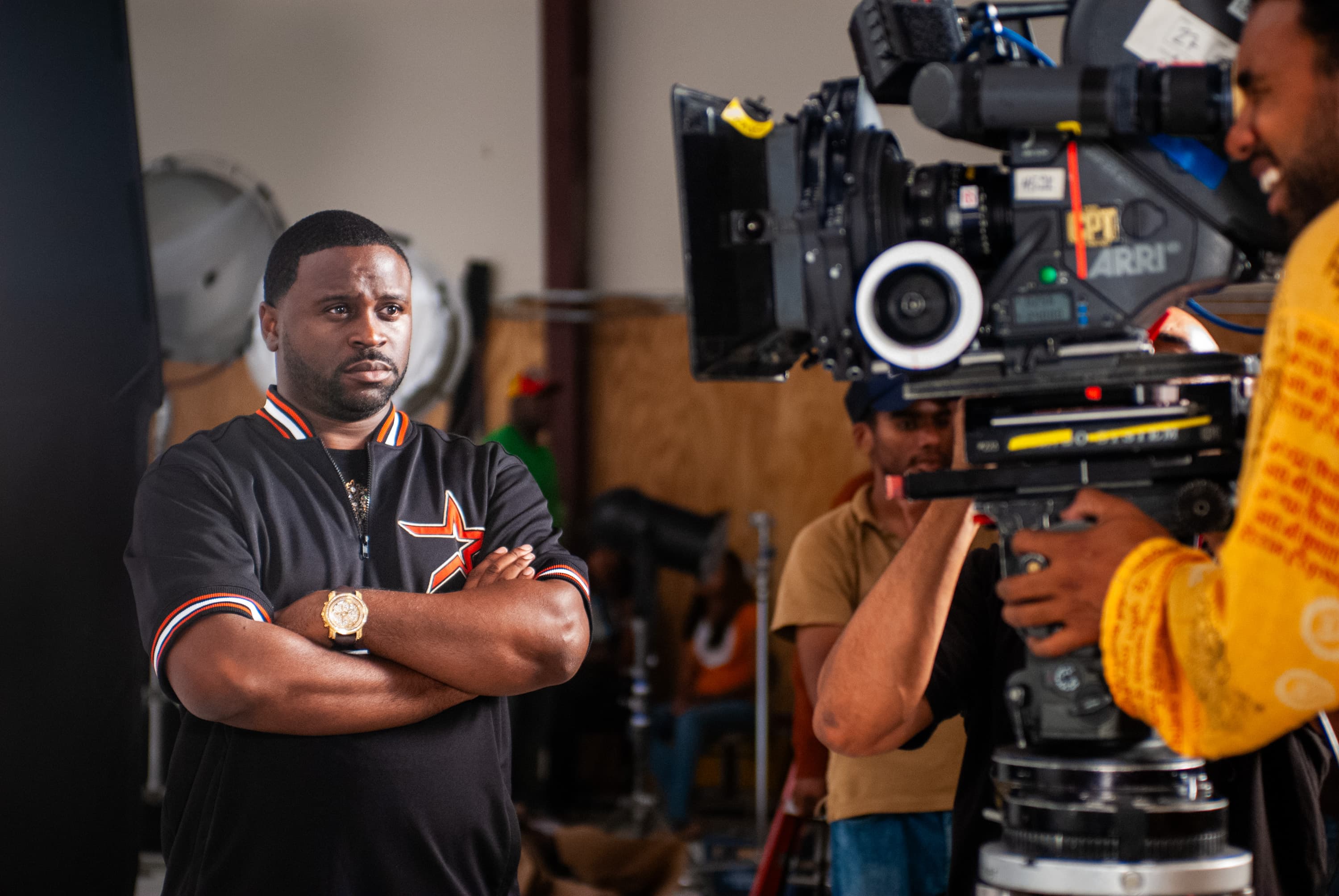 Director Dr. Teeth with arms crossed looking at movie camera in the foreground